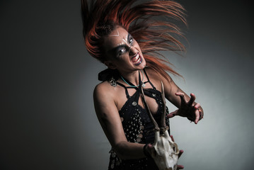 Enraged witch with a skull casting a spell