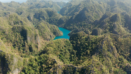Aerial drone Kayangan lake with blue water on tropical island Coron. Lake in the mountains covered with tropical forest. Palawan, Philippines