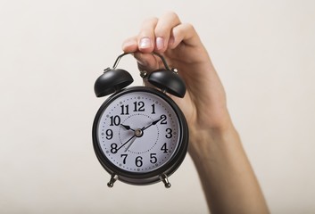 Hand Holding Alarm Clock