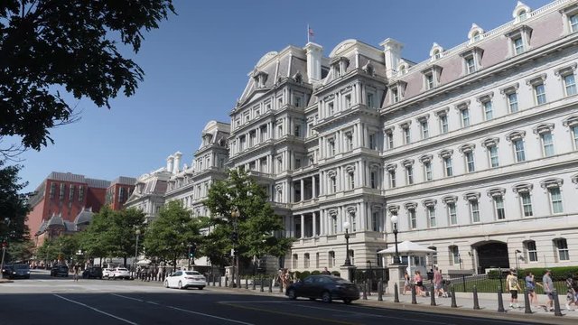 WASHINGTON, D.C. - Circa July, 2019 - A daytime exterior establishing shot of the Eisenhower Executive Office Building as traffic passes by on 17th Street.  	