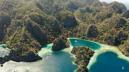 Aerial drone lagoons and coves with blue water among the rocks. lagoon, mountains covered with forests. Seascape, tropical landscape. Palawan, Philippines, Busuanga
