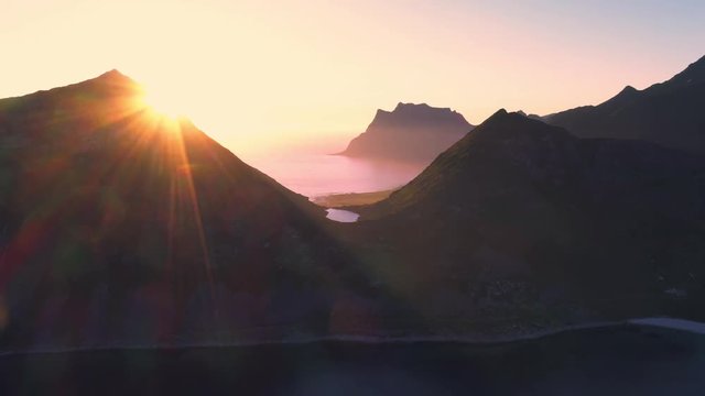 aerial view. sunset over Veggen and Mannen peaks, Haukland and Uttakleiv Beach in the Norway on the Lofoten Islands