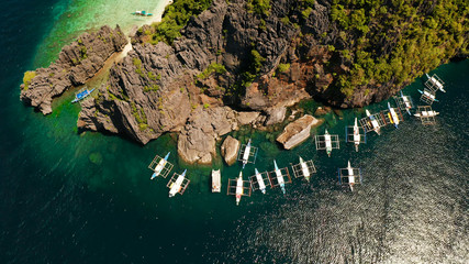 Tourist boats over tropical lagoon and coral reef, aerial view. El nido, Philippines, Palawan. Summer and travel vacation concept.