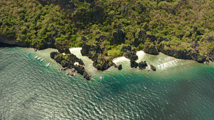 aerial view of tropical lagoon with sandy beach surrounded by cliffs. El nido, Philippines, Palawan. beautiful lagoon and karst scenery.
