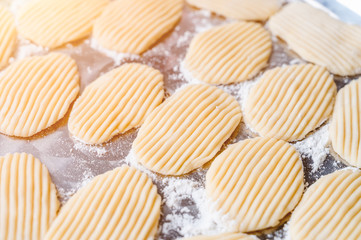 Close-up raw caramelized crisps flat dough in stainless steel tray.The popular traditional thai dessert.