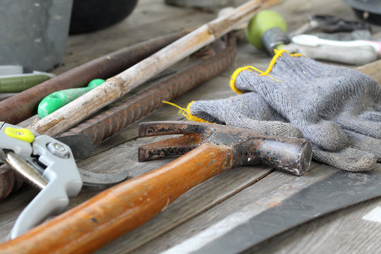 scatter of tools on dirty wooden table