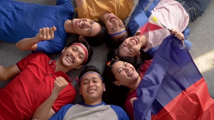 filipino group of people holding philippines flag celebrating independence day