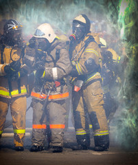 The group of firefighters fighting a fire