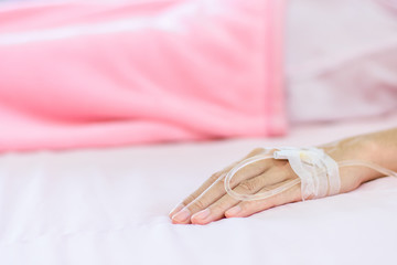 Close up of saline solution on  left hand of women patient.
