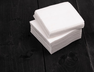 The white paper napkins on wooden background