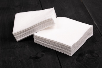 The white paper napkins on wooden background