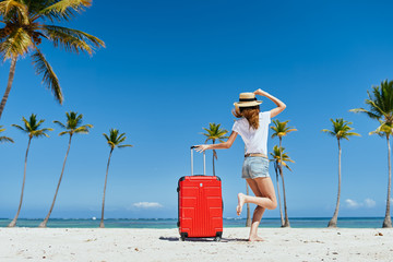 woman with cocktail on the beach