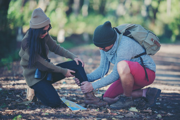 Couples traveling together in the forest, ankle injuries on a green background, hiking concepts
