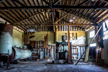 Abandoned Cannery Warehouse Interior with Rusty Machines and Deteriorating Wood