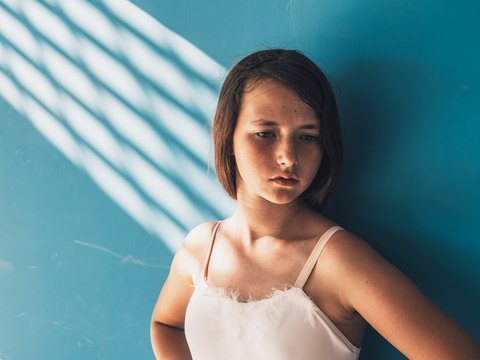 Thoughtful ballerina leaning on wall