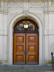 wooden double door entrance to old stone building