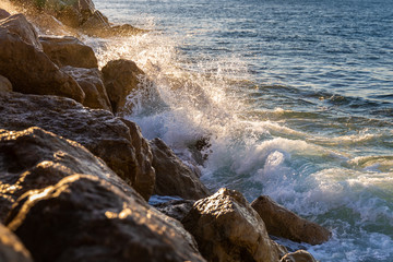 Splashing water from touching of strong wave on rocks