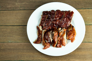Yummy slided juicy roasted peking duck on white dish 