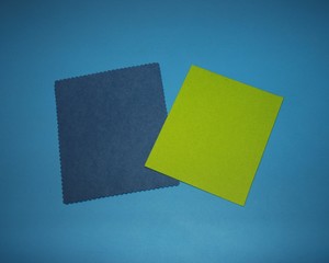 colored paper sheets of green, purple with a curly pattern lies on the table