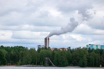 smoke from factory chimney on background of blue sky with clouds