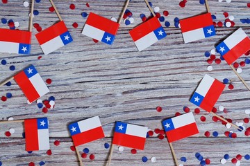 September 18, happy independence day of Chile. memorial day for independence. the concept of patriotism. mini flags with confetti on white wooden background