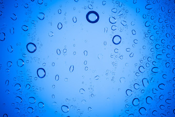 Water droplets on blue glass for a background, Drops of water