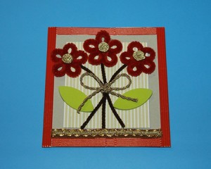 Valentine greeting card red flowers made of chenille wire for creativity bow gold on a blue background