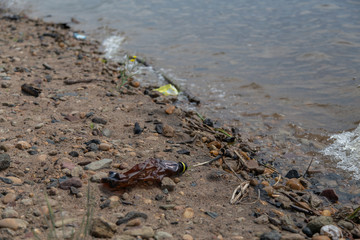 plastic bottle thrown on the shore. environmental pollution