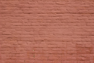 Antique old shabby chic brick wall texture background, bearing several layers of reddish brown paint