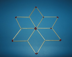 Wooden matchstick logic puzzle task geometric shape star