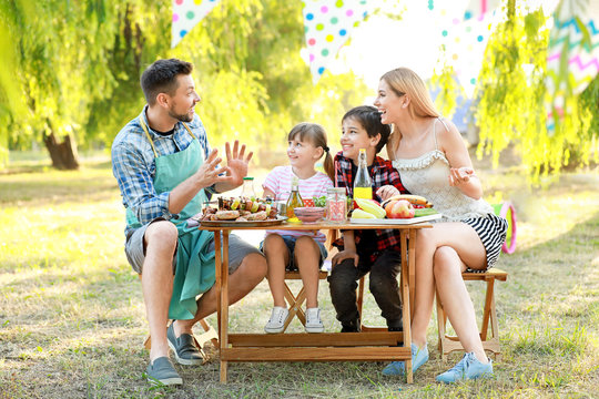 Happy family having picnic on summer day