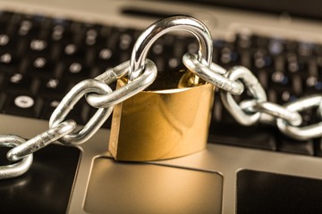 Padlock and Chain on a Laptop