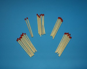 pile of wooden matches with a red tip head lie on a blue background