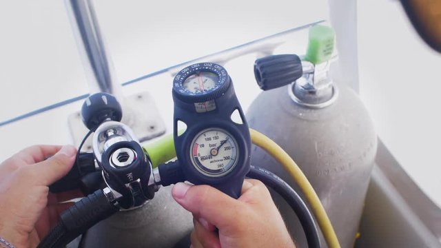 Scuba Diver Checks Pressure on Regulator Set - Needle Swings on Gauge