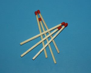 Wooden matches on a blue background laid out