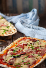 Pizza with cheese and salami. on a wooden table