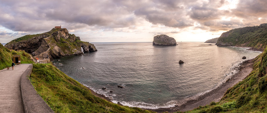 Panoramic view of calm seaside with touristic path on background of cloudy sky