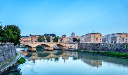 Fototapeta na wymiar Emanuele II bridge and St. Peter's Basilica at dawn.