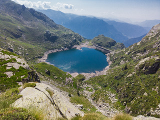 Fototapeta na wymiar Italian Alps. Italy. Wonderful view of the an alpine lake created by the dam barrier. Orobie. Valgoglio lakes