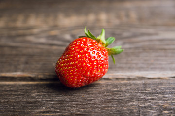 Ripe and juicy strawberries on the dark rustic background. Selective focus. Shallow depth of field.