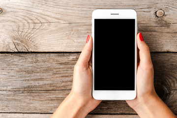 Woman using smartphone with empty black screen.