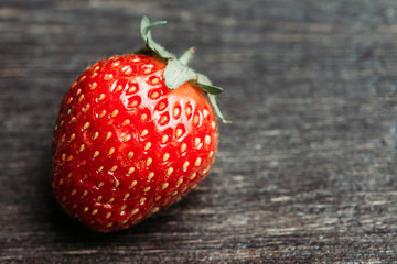 Ripe and juicy strawberries on the dark rustic background. Selective focus. Shallow depth of field.