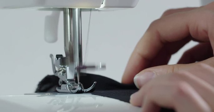 sewing a black cloth with a sewing machine