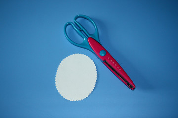 scrapbooking scissors, wave pattern, cardboard cut in the shape of a circle