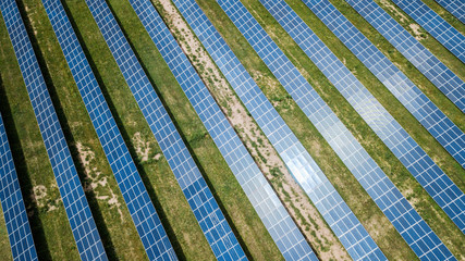 aerial view of solar panels on green lawn. drone shot, bird's eye