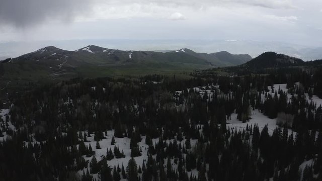 Aerial Shot Tracks Towards Distant Mountains and over forest. 4k