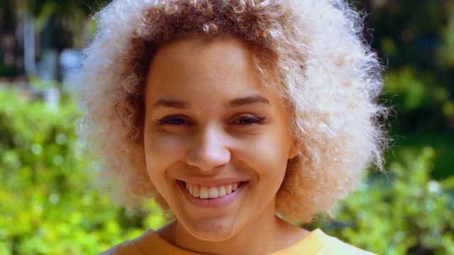 portrait mixed race girl looking at the camera posing and smiling