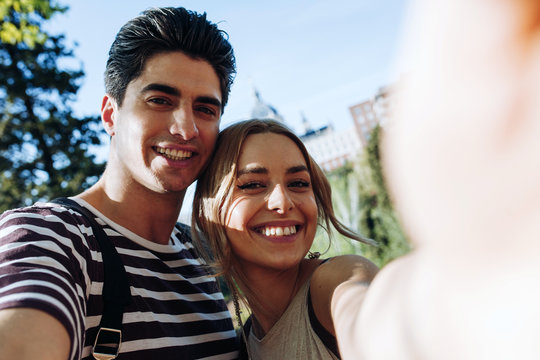 Portrait of smiling couple standing outdoors