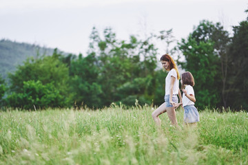 Fototapeta premium Mom and daughter walk in nature