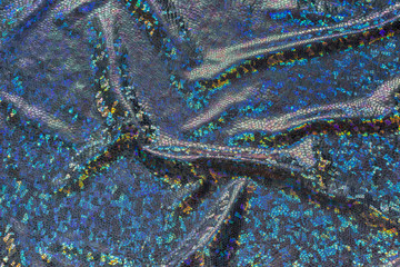 Dark blue fabric with folds and holographic elements. Abstract geometric background or texture